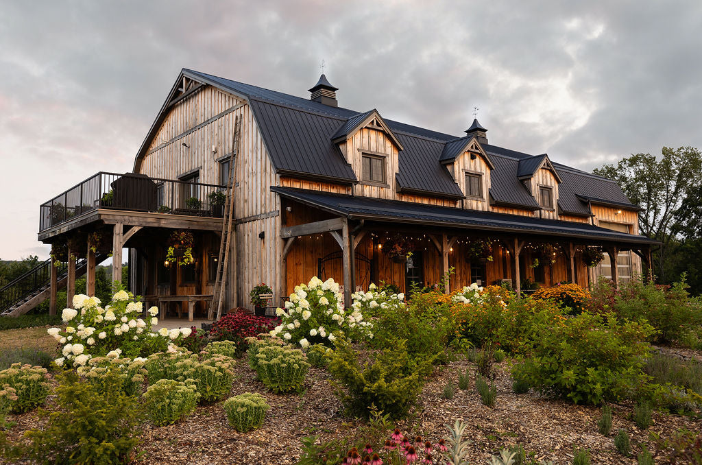 Close-up showing a wooden barn with black metal roof.